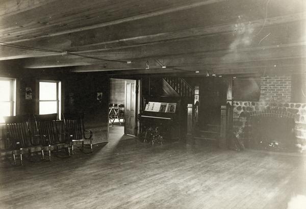 Interior of view of Old Mission Inn, showing stone fireplace and piano. The Old Mission Inn was razed in 1965.