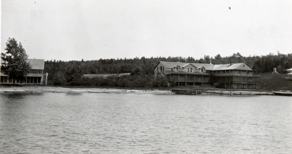 View from water of the Old Mission Inn on the shore of Lake Superior in La Pointe on Madeline Island. Dwelling to the left is a portion of the lower dormitory.