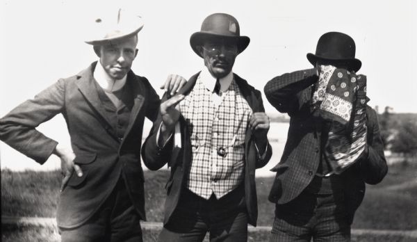 Oliver Wilson, Leo Capser, and Jesse Stone, all wearing hats, pose for a group portrait.