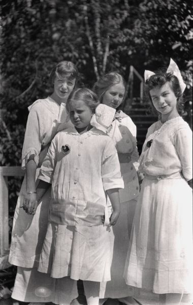 Four young girls posing in dresses. Louise Lock, Louise Baker, Elizabeth Baker, and Elizabith Nesbit (Mrs. S.C. Marty, SR.)