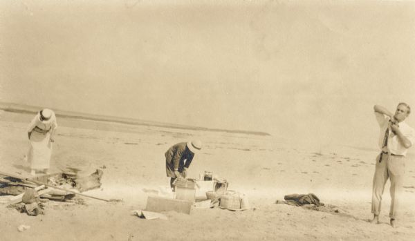 C.A. Hull, an unidentified person, and Mason L. Thompson on an Apostle Island beach for a picnic.
