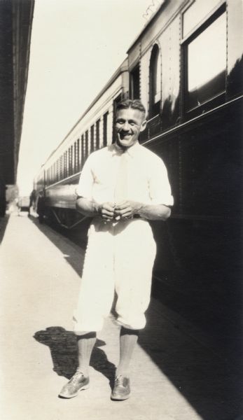 Leo Capser standing in front of passenger train at the Ashland Depot.