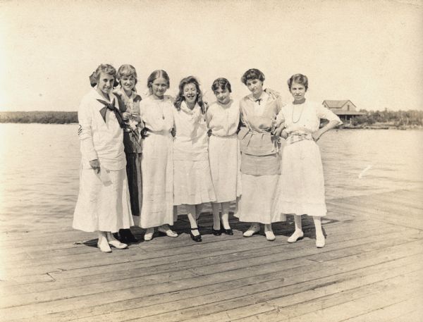 Seven teenage girls posing on a dock on on one of the Apostle Islands.