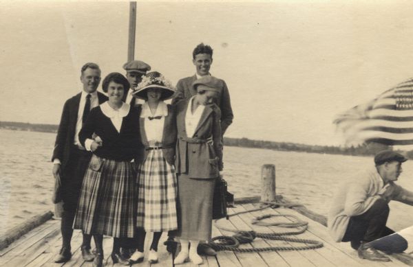 Group of men and women standing on Basswood Island Dock. Bill Baker, Elizabeth Hull, Florence Baker, Dorothy Stickney Ross, Louise Baker, Hamilton N. Ross (Basswood Island)