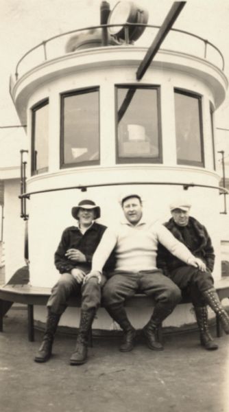 Three men posed on the "Madeline." This is a Canadian trip hosted by Henry Woods.