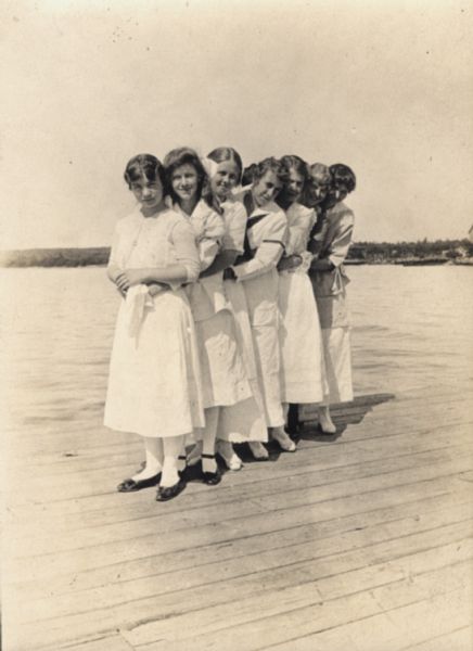 Seven girls lined up on Madeline Island Dock.