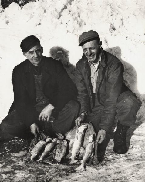 Vern Frechette (left) and Leonard Larson show their catch of trout caught during ice fishing on Chequamegon Bay.
