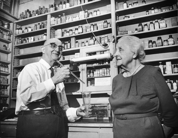 Mr. and Mrs. Janke taking care of last minute details in their prescription department before closing their drugstore's doors at 1658 W. Hopkins permanently. The couple retired after being in business for 56 years.
