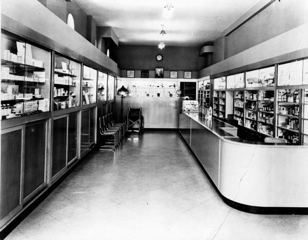 View of the long and narrow Lascoff's Pharmacy. The dispensary is located in the rear of the store. A small waiting area is directly across from the prescription drop-off and pick-up area.