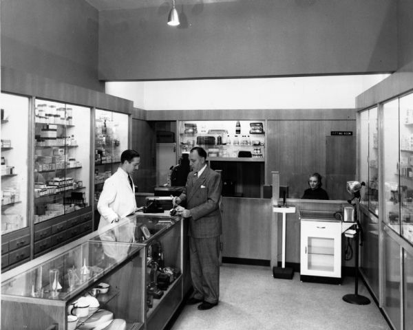 A pharmacist assists a customer in Joseph Lascoff's Pharmacy, located at 93rd and Amsterdam.
