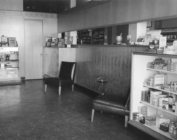 Cabinet of sundries (toothpastes, shaving supplies, aspirin, etc.) next to the waiting area at Joyce Smith Gaines' Pharmacy.