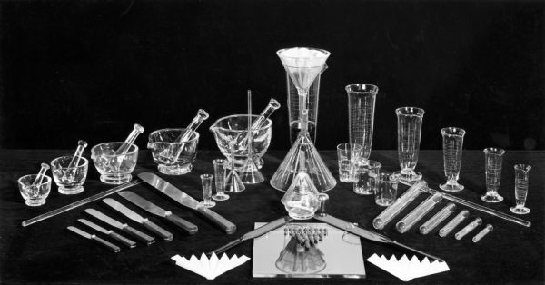 Display of pharmaceutical glassware, including several mortars and pestles, at the Professional Pharmacy.