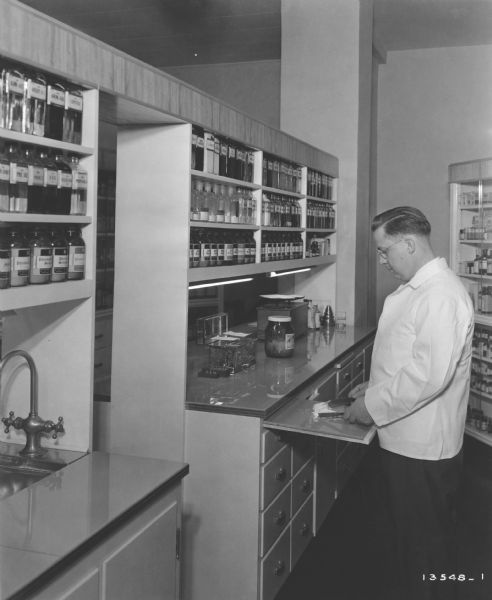 Druggist Joseph O' Donnell jots down some notes in his pharmacy's laboratory.