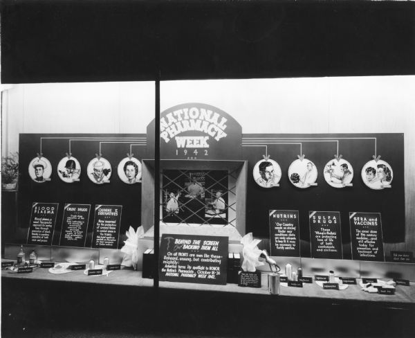 Display in the window of a pharmacy promoting National Pharmacy Week. National Pharmacy Week was used as a way to help educate consumers about the role pharmacy played in their everyday lives. This exhibit illustrates the many ways in which pharmacies helped to win World War II.