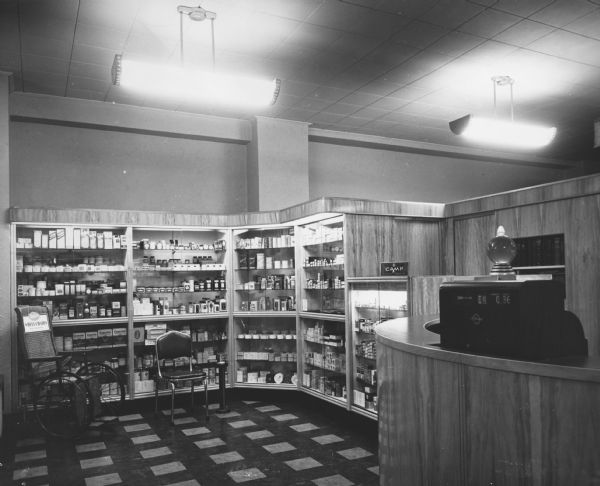 The rear of Joseph O' Donnell's Pharmacy. The counter on the right was for prescription pick up. The cabinets to the left contain various medical supplies.
