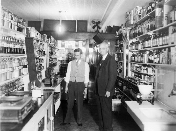 Proprietor George Judisch (right)  and a clerk in his pharmacy's prescription department.