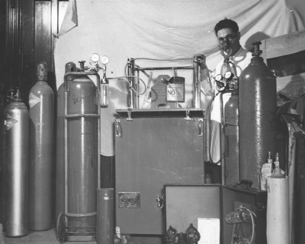 Thomas Tesiero poses with the tanks in Tesiero's Pharmacy's oxygen therapy department.