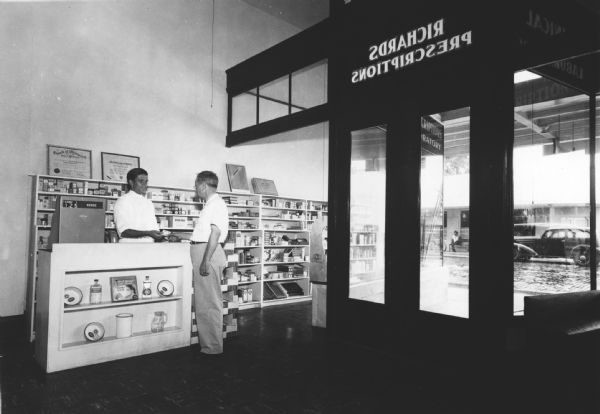 A customer picks up a prescription at Richards Brothers' Pharmacy.