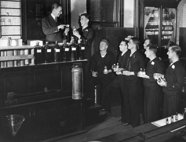 Members from the U.S. Coast Guard Hospital Corps School meet in the pharmaceutical laboratory where they checked medicinal products and learned to identify some of the basic ingredients they may have needed to use for their doctoring at sea.