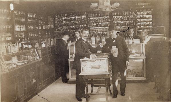 Druggist Junior Jones shows a customer some items from the J.N. Hegeman Pharmacy, 1218 Broadway.