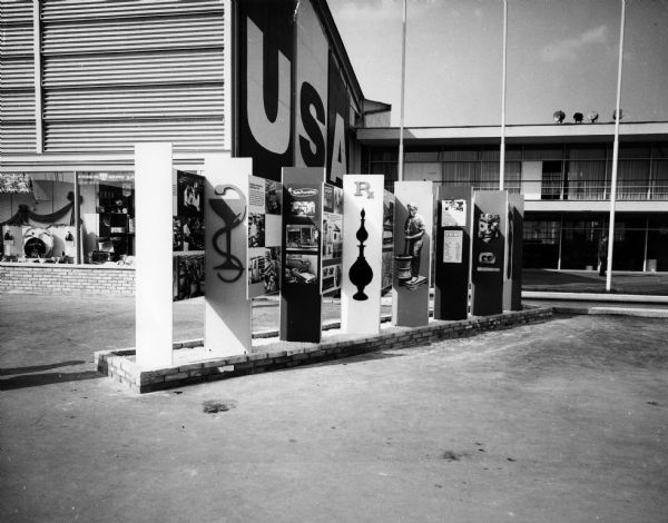 This exhibit entitled "Pharmacies U.S.A." greeted nearly one-half million visitors at the main entrance of the U.S. Pavilions at the International Trade Fair, Zagreb, Yugoslavia, September 10-25, 1960. The series of panels, developed by the Office of International Trade Fairs, U.S. Department of Commerce, with the technical assistance of the American Pharmaceutical Association, traces the history of American Pharmacy, and presents a pictorial view of the many types of pharmacies common in the U.S.A. today, including typical photographs of an exclusive prescription pharmacy, a hospital pharmacy, and a small town "corner drug store."