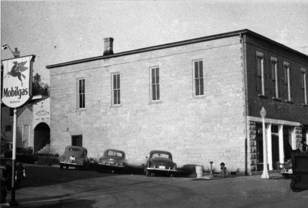 Corner of Canal and Congress streets, showing a building erected by James Sprague and Lyman D. Holford in 1880. Two stores occupied the ground floor, including Holford's Drug Store. The upper story was used as an opera house/hall, and is said to have had a capacity of between four and five hundred.