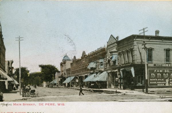 View of businesses on Main Street, including the City Drug Store and a dentist.