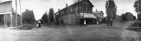 Corner of Arndt and Doty streets, showing one of the early electric street cars in Wisconsin. The tower, the bottom of which shows in the picture, was one of five high structures which mounted a group of carbon arc lights and made Fond du Lac one of the first cities in the state to have electric street lighting. The building on the corner is Reeves and Son, Druggist.