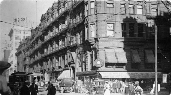 View of the intersection of Second Street and Grand Avenue (later renamed Wisconsin Avenue). Pictured on this corner is Dadd's Drug Store, 137 Grand Avenue, which was operated by Robert M. Dadd between 1907-1915.