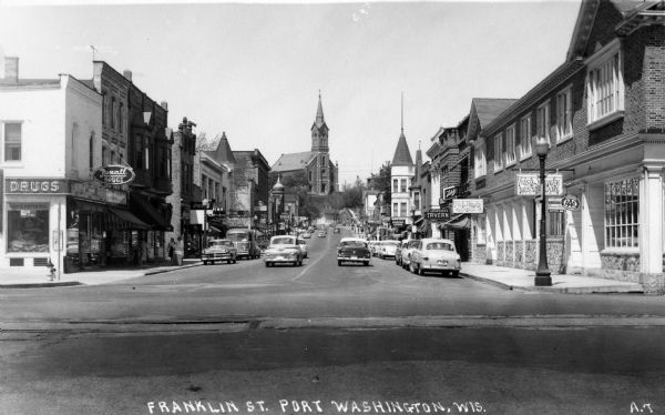 View of the central business area on Franklin Street. On the right corner is the "Fish Shanty" Restaurant and on the left is the Rexall Drugstore.