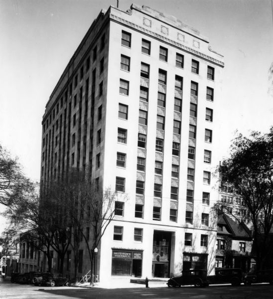 View of the Wisconsin Power & Light Company Building, 122 West Washington Avenue on the corner of Fairchild Street. Helstrom's Pharmacy occupies a large portion of the ground floor.