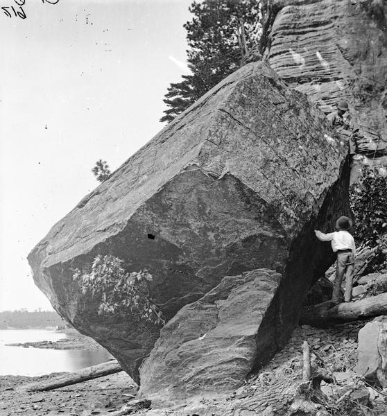 Devil's Football. There is a boy standing on a log at the right near the rock formation.