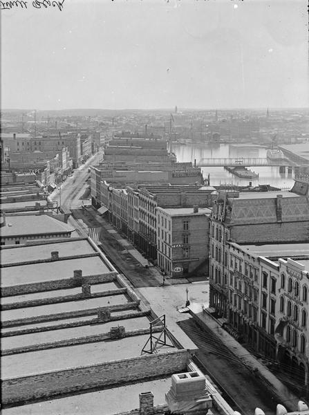Milwaukee, south from Mitchell Block. View shows rooftops and building fronts. Ships and bridge are in the background on the right.