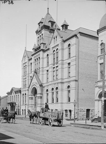 Turner Hall in Milwaukee with horse-drawn wagon passing.