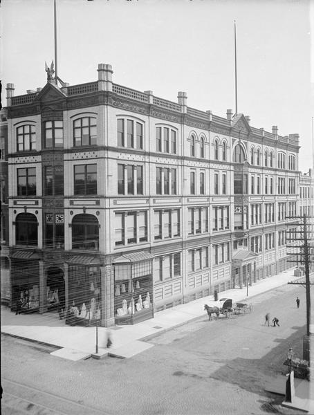 Elevated view of T.A. Chapman's new store with a horse and carriage next to it.