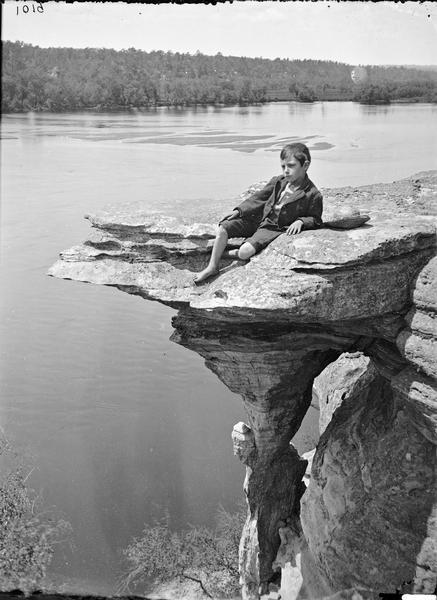 Bracket at the mouth of Witches' Gulch, with boy a posing sitting on the edge.