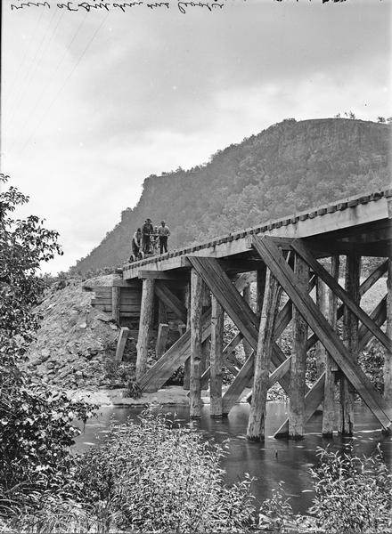 Upper Mississippi, view at Riley's Coolie. Four men are on a railroad handcar that is crossing a railroad bridge over the river.