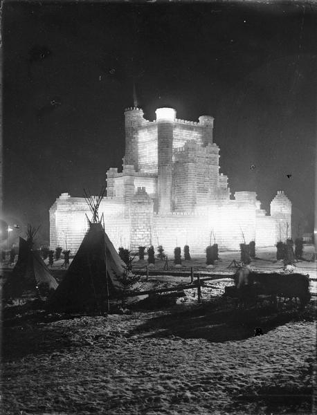 St. Paul Ice Carnival; Ice Palace at night with tents in foreground.
