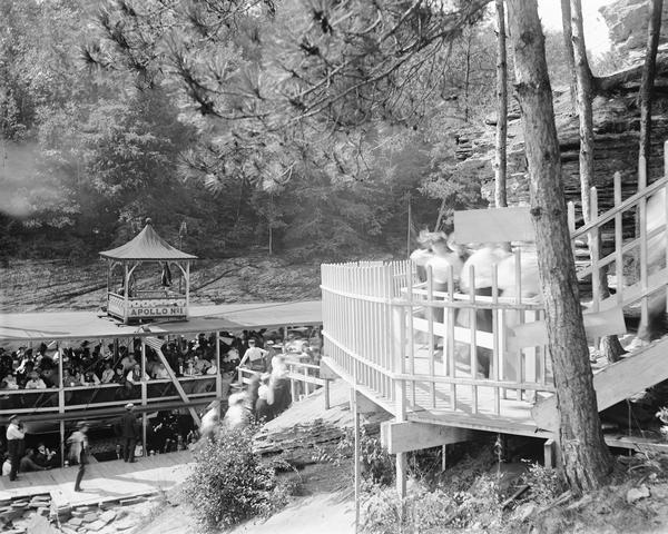 View from shoreline of Larks Hotel landing and stairs with passengers disembarking "Apollo No. 1" steamboat.