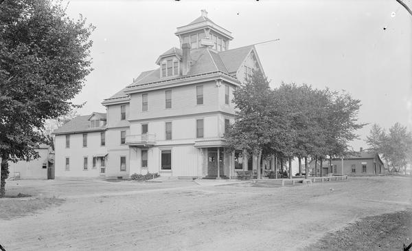 Exterior view of Hile House Hotel. There is a belvedere in the center of the roof.