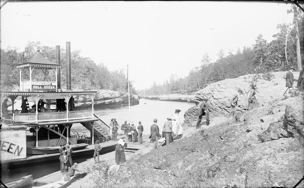 Passengers disembarking the "Dell Queen" steamboat at Cold Water Canyon.