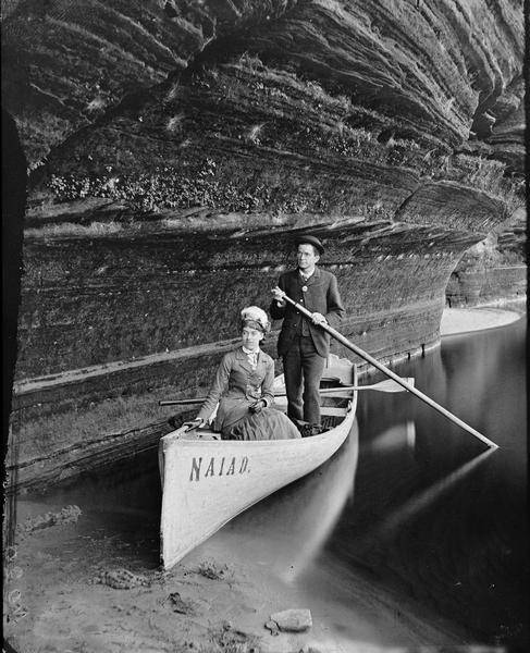 Mrs. and Mr. Clarence Bennett in boat "Naiad" at unidentified location.