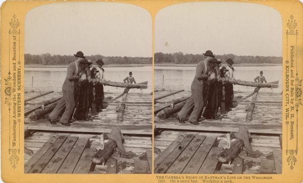 Stereograph of a group of raftsmen on a sandbar working a jack.