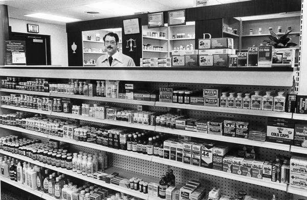 Michael Persten standing behind the prescription counter of The Medicine Shop, a pharmacy he opened in Wauwatosa.