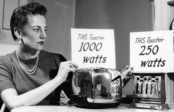 Woman comparing toaster wattages.
