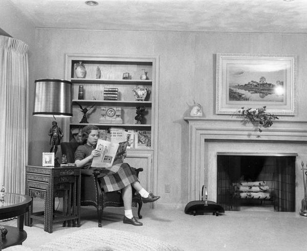 Woman reading "House Beautiful" magazine at Greenwood House.