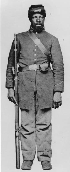 Full-length portrait of an African American Civil War soldier from Hughes and Meltzer, "A pictorial History of the Negro in America."