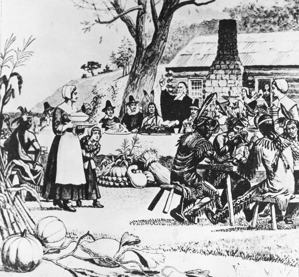 Thanksgiving dinner between Native Americans and early Pilgrim settlers in America.