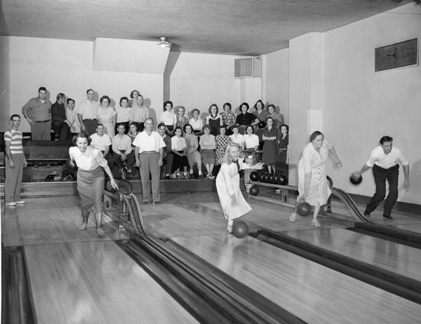 People bowling at an alley.