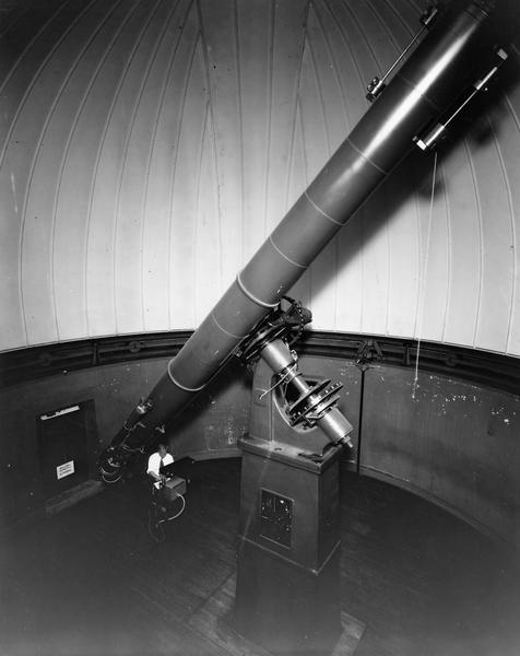 Telescope at Washburn Observatory with man at controls.